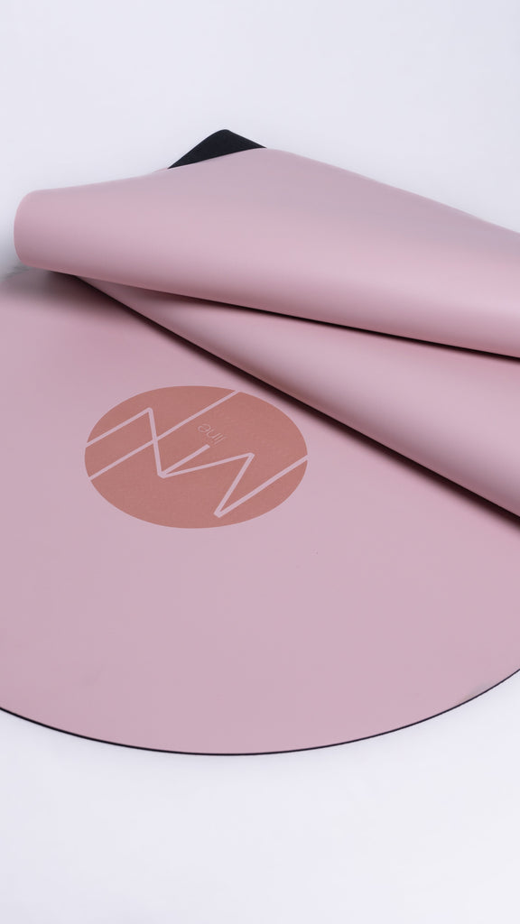Pink yoga mat with a logo on a white background